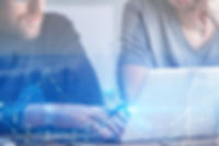 Employees Preforming Due Diligence on Laptop with Blue Lights