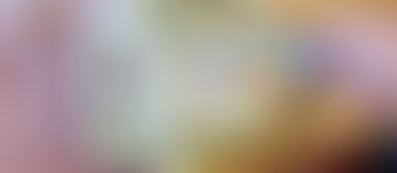 Close-up of draining old engine oil from a lawn mower into a 4-litre plastic bottle, showing a simple DIY oil change tray hack.