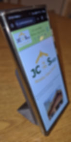 Anker 622 MagGo used as a phone stand, holding a smartphone upright with a webpage displayed."