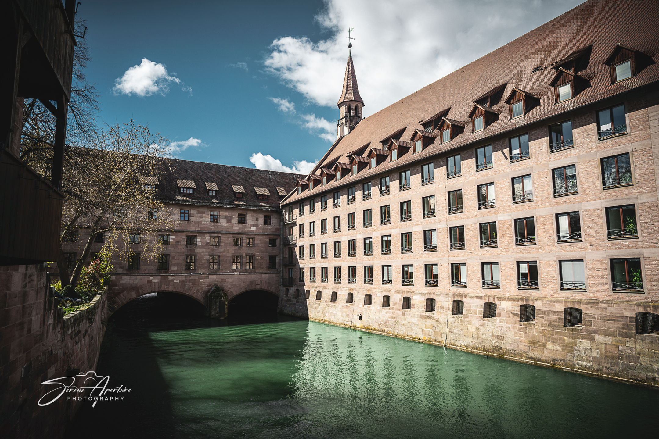 A waterway at the edge of a town square in Germany. Fine art perfect for home, office, lobbies, and more for all to enjoy!