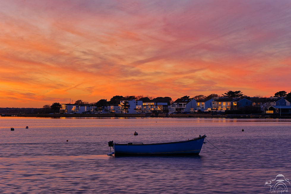 A boat in the bay basking in the afterglow of a Mudeford Sunset