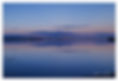 Christchurch Harbour after Sunset reflecting the scene in the calm water looking towards Mudeford and the Harbour entrance to the right of the picture.