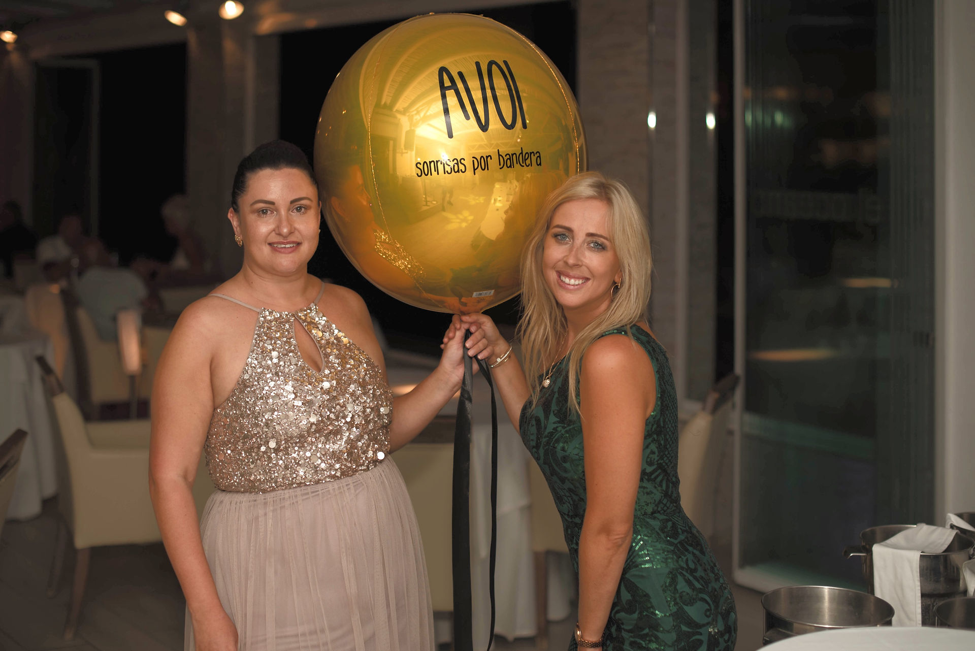 Large gold orbz helium balloon with a branded logo