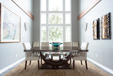 Remodeled dining room, with two-story windows and a luxury dining table and chair set
