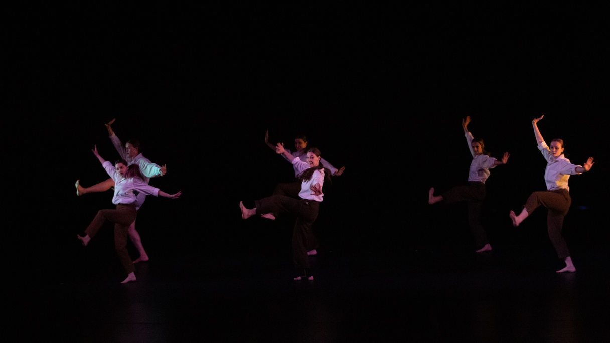 Six dancers standing on one leg playfully in a wide formation. Photo by CadenJohn Photography