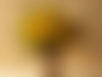 Handcrafted sunflower bouquet wrapped in kraft paper and rustic rope, styled with fresh greenery in warm natural lighting