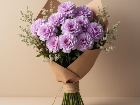 Lavender carnations bouquet wrapped in kraft paper and rustic rope, styled with baby's breath — representing Oscar Blooms' signature floral aesthetic.