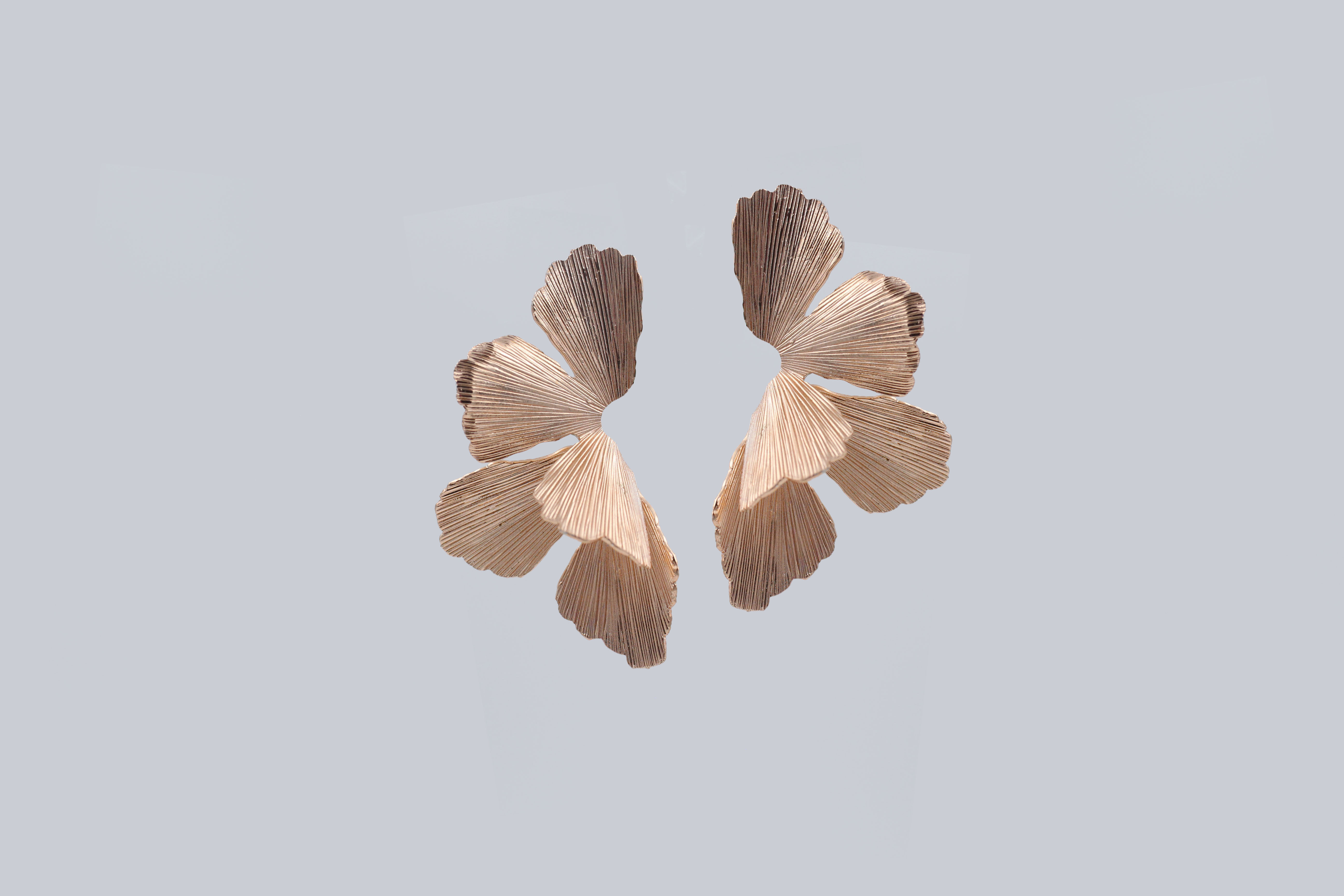 Elegant orchid-shaped earrings inspired by blooming flowers — floral statement jewelry with delicate petal details, perfect for nature-inspired or botanical fashion trends