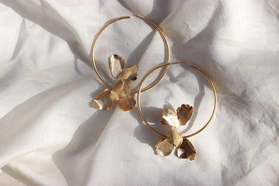 Elegant orchid-shaped earrings inspired by blooming flowers — floral statement jewelry with delicate petal details, perfect for nature-inspired or botanical fashion trends