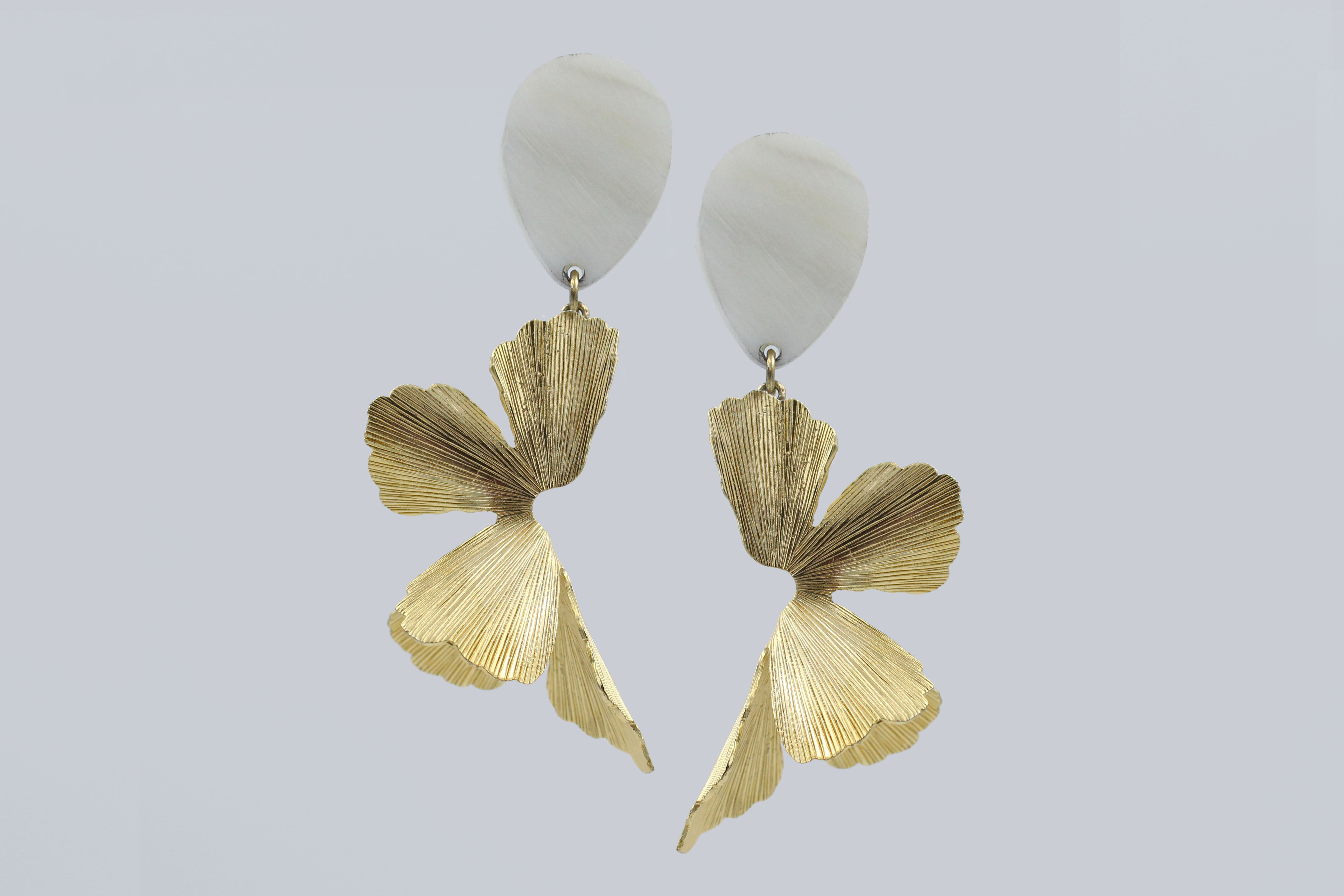 Elegant orchid-shaped earrings inspired by blooming flowers — floral statement jewelry with delicate petal details, perfect for nature-inspired or botanical fashion trends