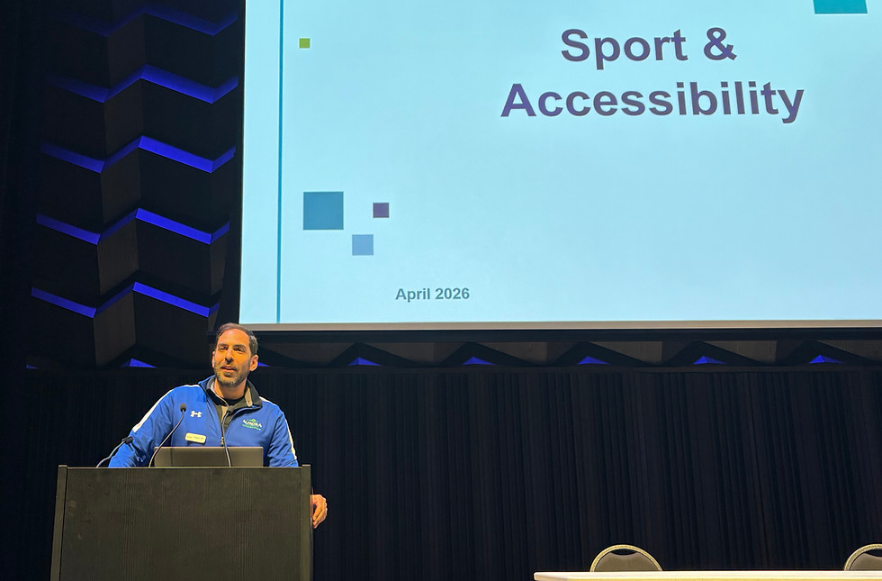 Gregory at a podium, presenting on Sport and Accessibility
