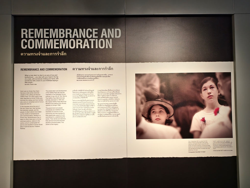 Display panel titled "Remembrance and Commemoration" with text in English and Thai. Features a sepia photo of two thoughtful children.