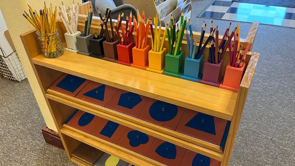 color pencils and metal insets prepared for a Montessori classroom, prepared environment, wood shelf