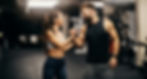 A fitness couple is celebrating success and giving bro handshake in a gym._edited.jpg