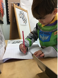 Child writing with a pencil