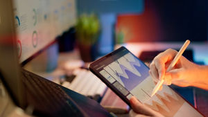 A person reviewing analytics on a pad