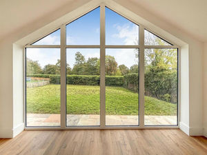A contemporary interior created via a combination of timber frame structure and steel support work allows unobstructed views to the garden.