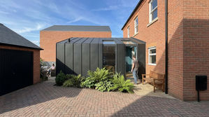 New access from the driveway to the kitchen area via wall to roof windows and doors.
