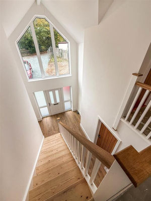 The double height entrance brings natural light into the hallway, landing and kitchen and living sapce beyond. This keeps the house feeling bright and airy all throughout the day.