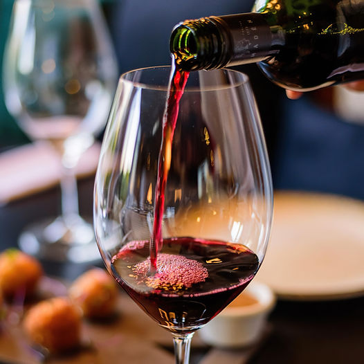 glass-wine-is-being-poured-into-wine-glass.jpg