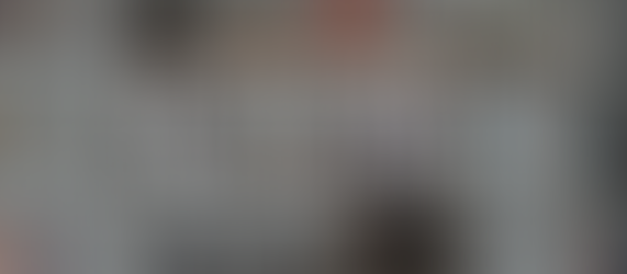 Person reaching for a book on a colorful bookshelf. Text overlay: Creative Writing Crash Course, Genres & Story Types, Lesson II.