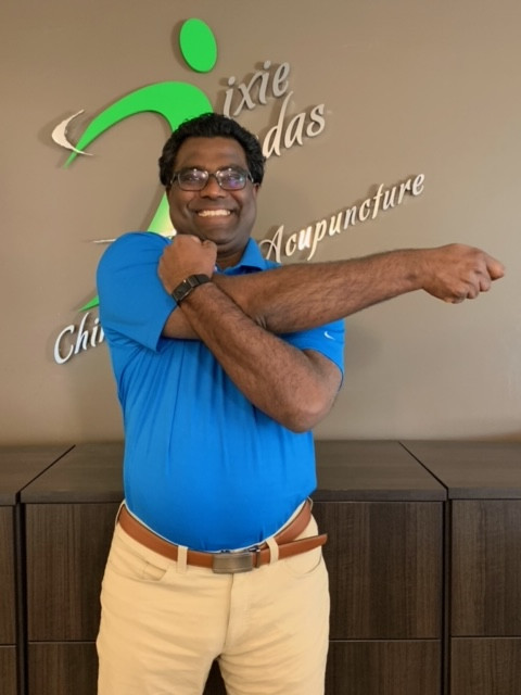 Dr. Andre demonstrating bent arm upper back and shoulder stretch