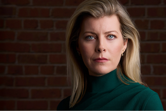 A dramatic headshot Danielle Maddox, Los Angeles based actress, wearing a green shirt.