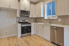 Cozy farmhouse kitchen featuring rustic wooden cabinets, a large island, and charming details.
