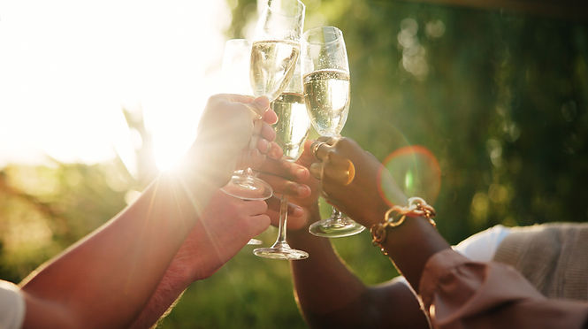 People, hands and glass with champagne for cheers, celebration or festive time together in