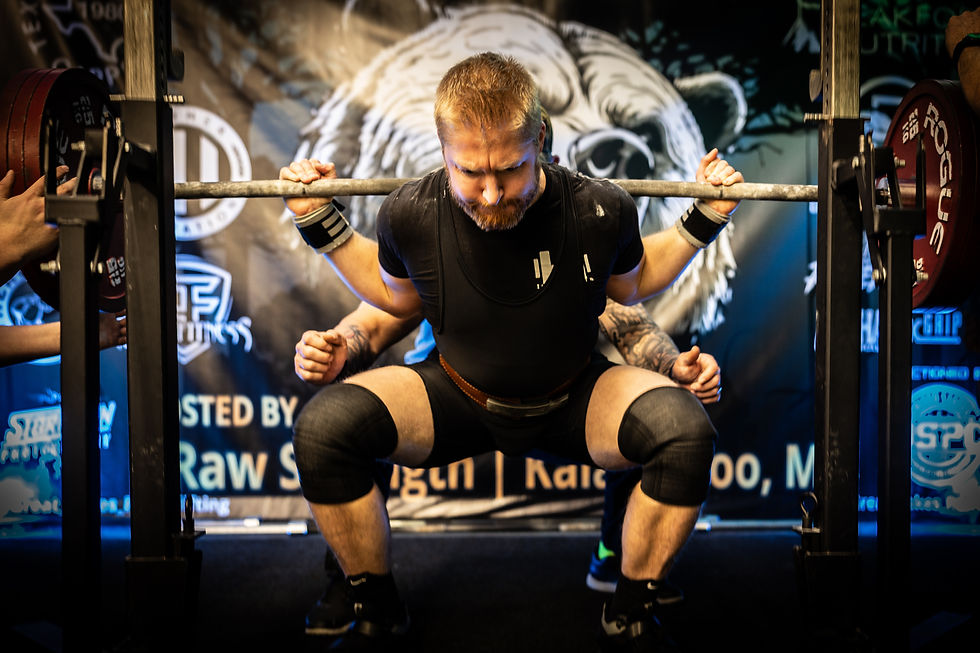 Man squatting in powerlifting competition