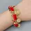 Thumbnail: Red Coral Gold Plated Edge Beaded Bracelet w/ Medallion Charms
