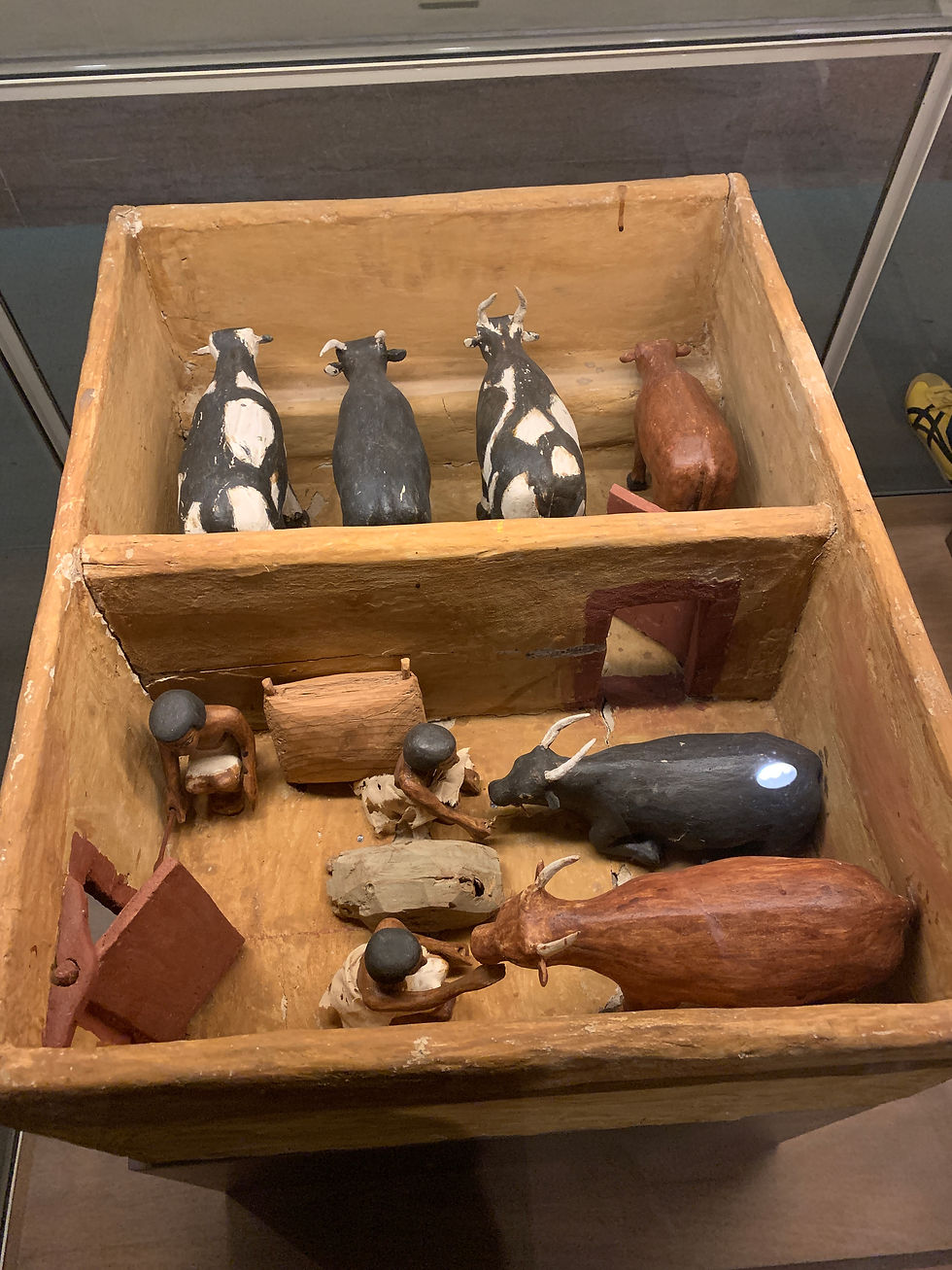 A picture containing indoor, cabinet, wall, building, basically a representation of a cattle stable back in the days in Egypt