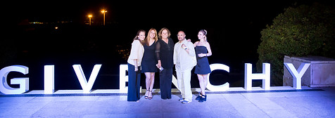 Givenchy fashion event with the brand's logo illuminated in the background