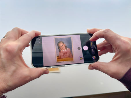 Scanning old family photos near indirect window light helps reduce glare and reflections while improving overall image quality.