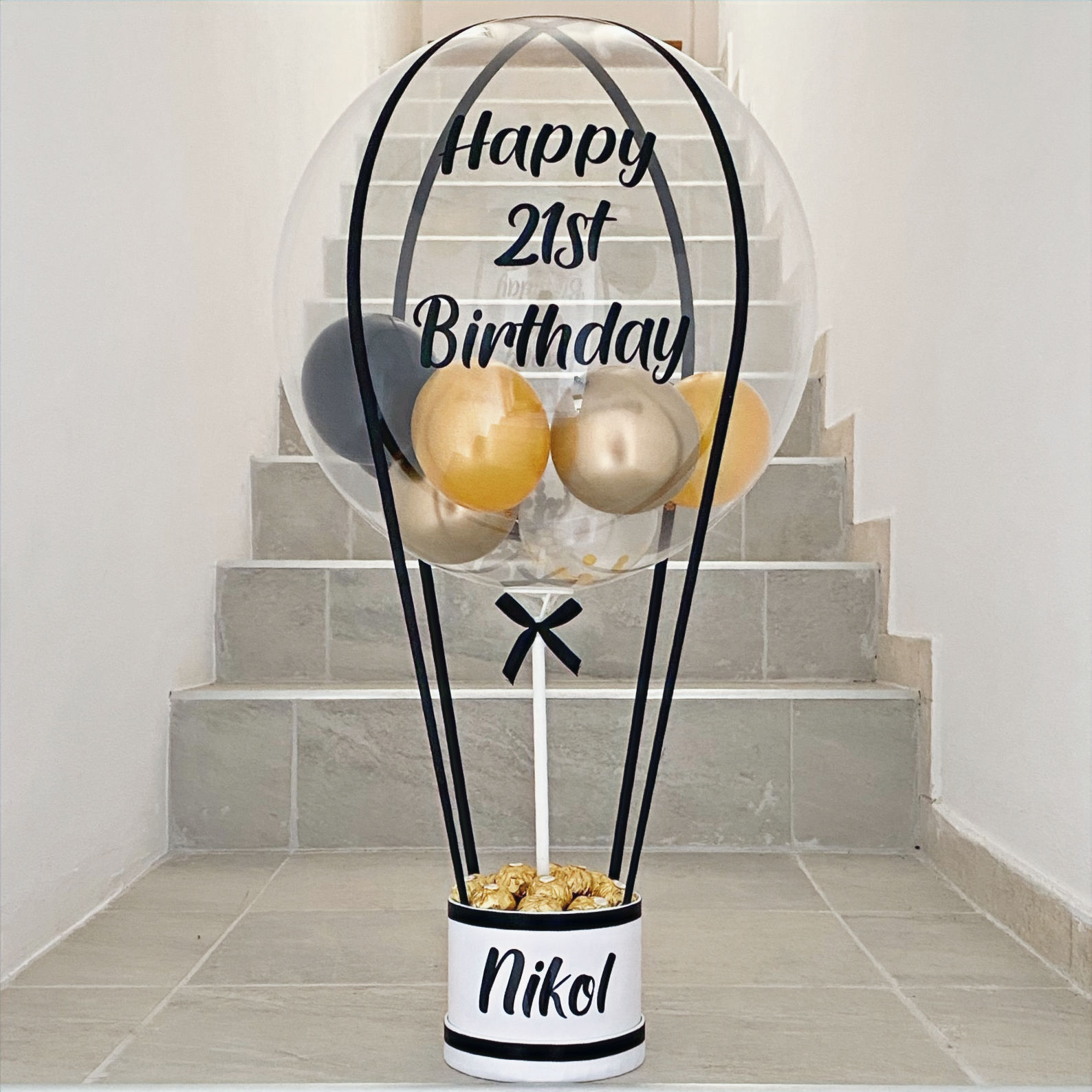 Birthday balloon with text Happy 21st Birthday and the name Nikel. Balloons inside.