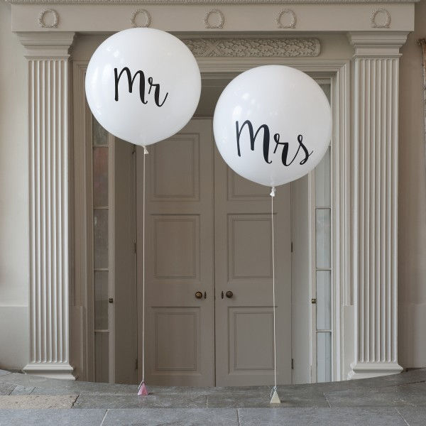 Two white balloons with "Mr" and "Mrs" text, wedding decorations, doorway backdrop.