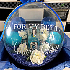 Clear balloon gift says, "FOR MY BESTIE" and "Mary Claire", blue background.