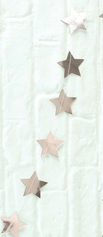 Thumbnail: Three copper stars hanging against a white brick wall background.