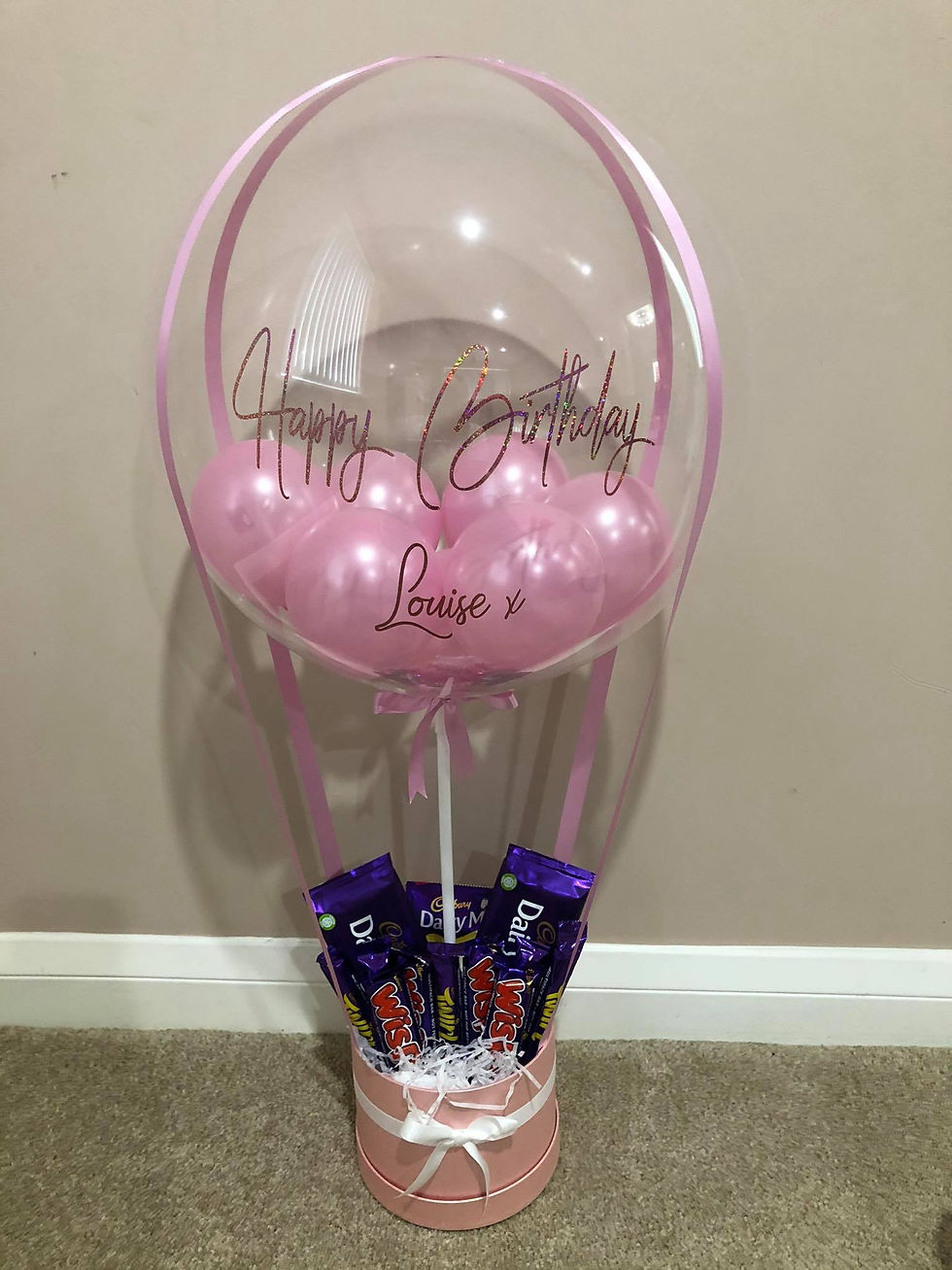 Pink balloon with "Happy Birthday Louise" and chocolates below; Party World Ferndown