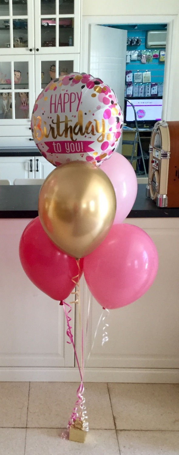 Pink, gold, and white balloons. Says