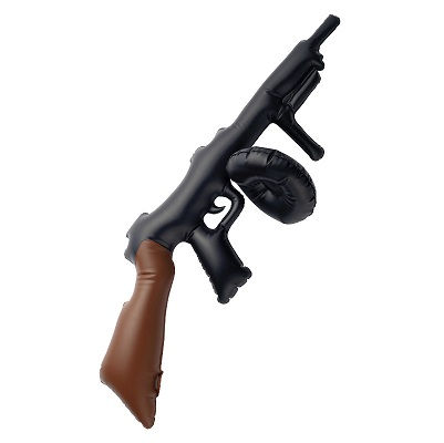 Toy black machine gun with brown handle, resting on white background.