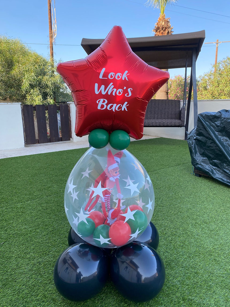 Red star balloon says Look Who's Back with clear balloon base on grass