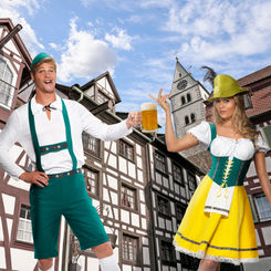 Couple in traditional costumes holding beer mugs and celebrating, fancy dress costumes for adults.