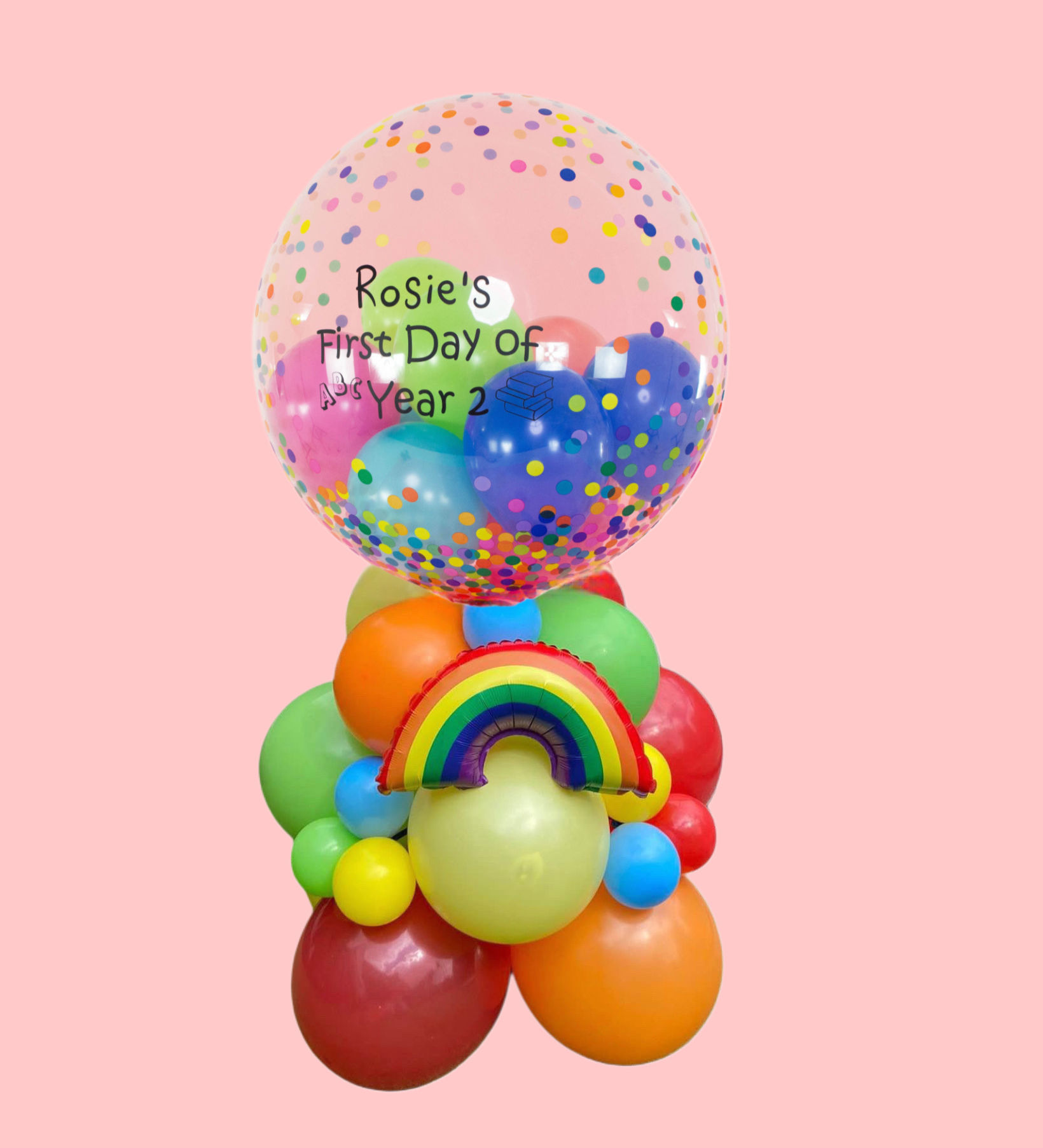 Rosie's First Day of Year 2 colorful balloon arrangement with rainbow and confetti.