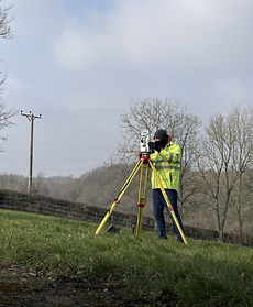 man using total station equipment