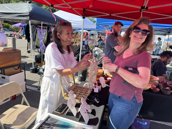 Rocio Illanes being visited by Member, Heather Harris, at the May market