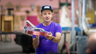 Kalimar Holding one of his Handmade guitars at the Nova Labs Open House