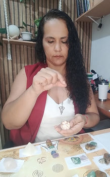 Mulher com pendulo e cristal na mão