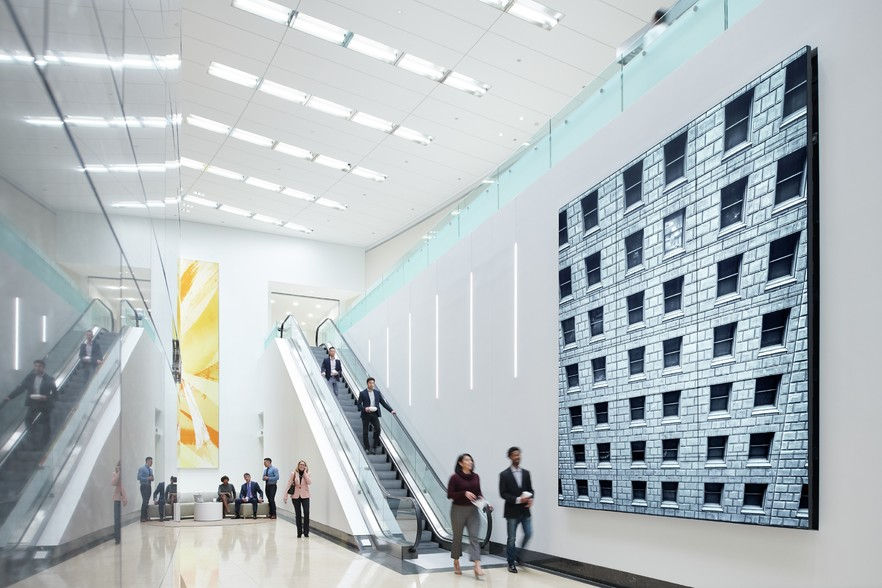 CBRE, Oak Brook, Illinois: Custom walnut paneling and hardwood flooring establish a refined arrival experience while reinforcing the firm's professional brand identity.