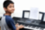 boy playing keyboards.jpeg